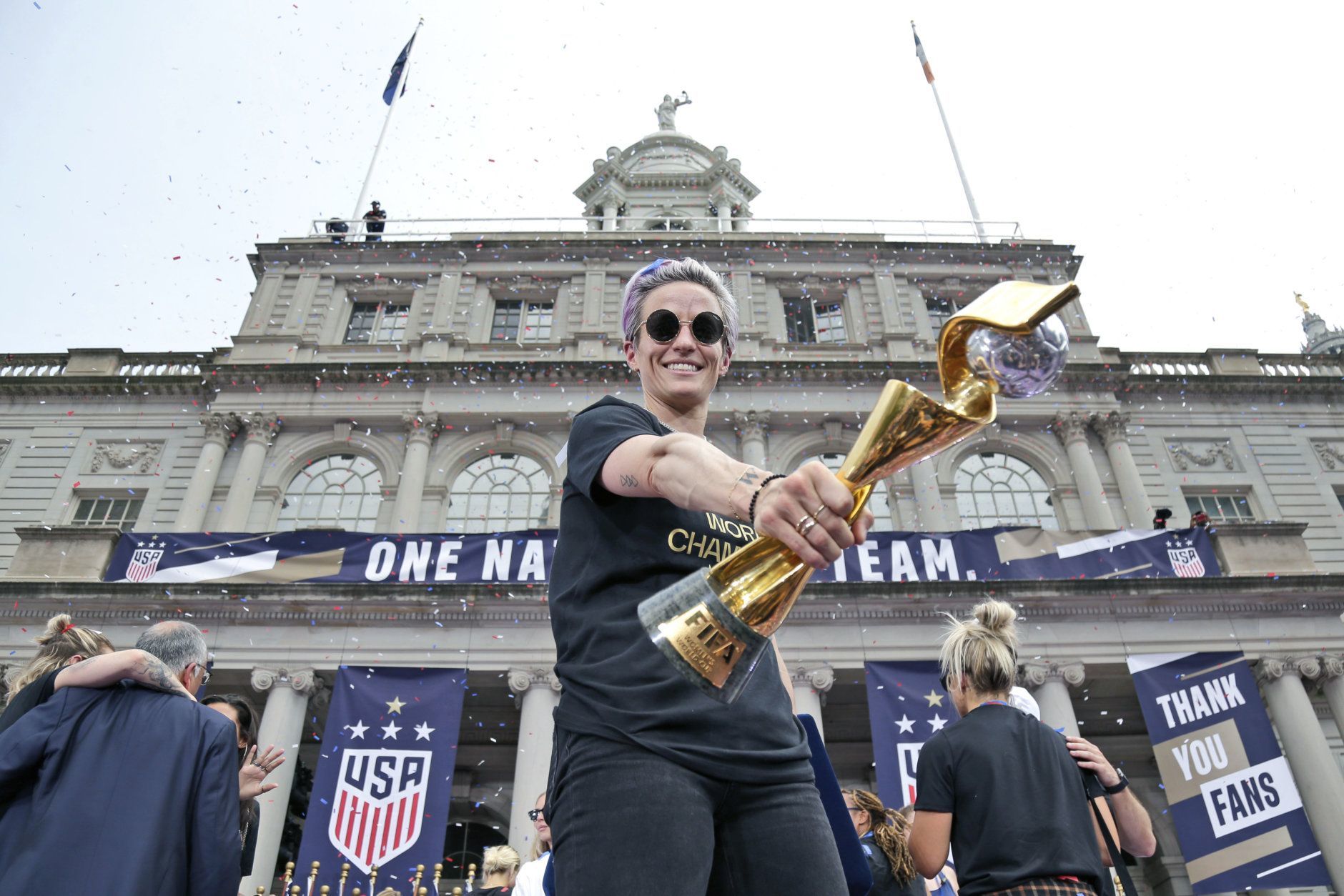 The U.S. women's soccer team member Megan Rapinoe holds the championship trophy at City Hall after a ticker tape parade, Wednesday, July 10, 2019 in New York. The U.S. national team beat the Netherlands 2-0 to capture a record fourth Women's World Cup title. (AP Photo/Seth Wenig)