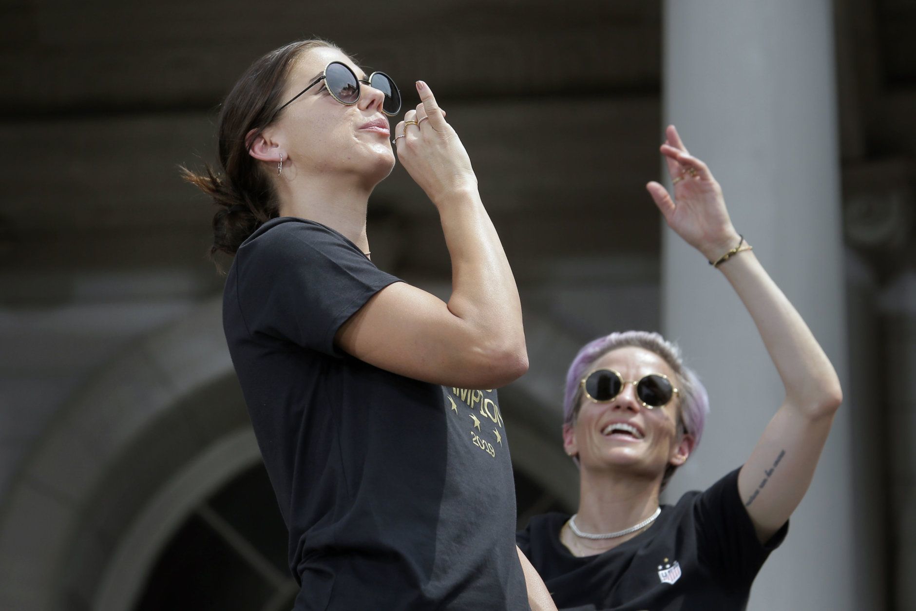 The U.S. women's soccer team captains' Alex Morgan, left, and Megan Rapinoe celebrate at City Hall after a ticker tape parade, Wednesday, July 10, 2019 in New York. The U.S. national team beat the Netherlands 2-0 to capture a record fourth Women's World Cup title. (AP Photo/Seth Wenig)