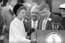 Virginia Governor Gerald Baliles, right, share the podium with Virginia Lt. Governor L. Douglas Wilder, center, and Attorney General Mary Sue Terry, left, after the three were sworn in at the Capitol in Richmond, Virginia on Jan. 11, 1986. (AP Photo/Steve Helber)