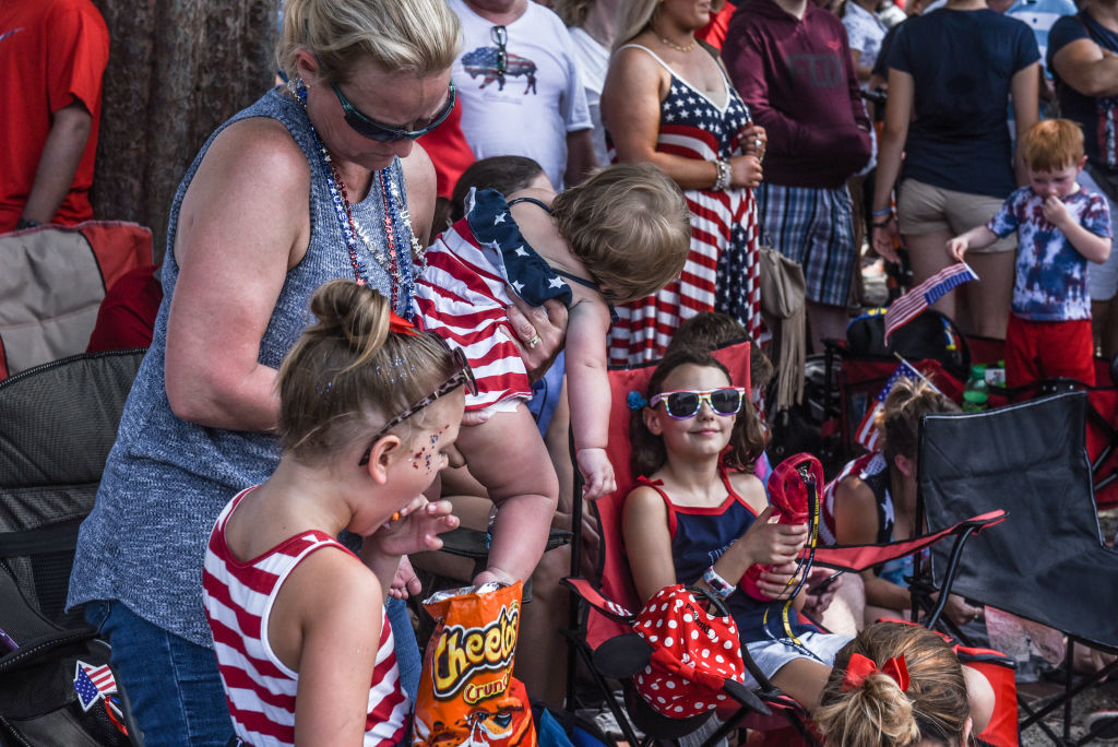 WASHINGTON, DC - JULY 04: People participate in the Fourth of July festivities on July 4, 2019 in Washington, DC. President Trump is holding a "Salute to America" celebration on the National Mall on Independence Day this year with musical performances, a military flyover, and fireworks. (Photo by Stephanie Keith/Getty Images)