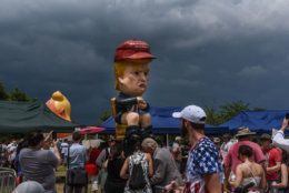 WASHINGTON, DC - JULY 04: People pass by a sculpture of President Donal Trump on a toilet during the Fourth of July festivities on July 4, 2019 in Washington, DC. (Photo by Stephanie Keith/Getty Images)