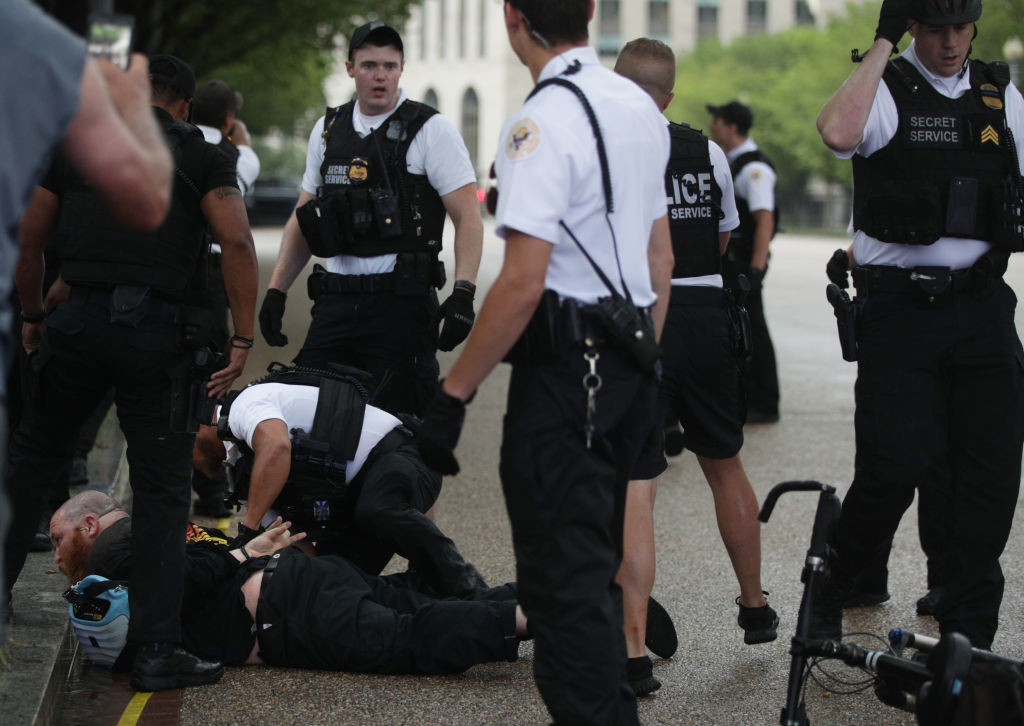 WASHINGTON, DC - JULY 04: Members of the U.S. Secret Service detain a man after an attempted flag burning in front of the White House on Independence Day July 4th, 2019 in Washington, DC. President Trump is holding a "Salute to America" celebration on the National Mall on Independence Day this year with musical performances, a military flyover, and fireworks. (Photo by Alex Wong/Getty Images)