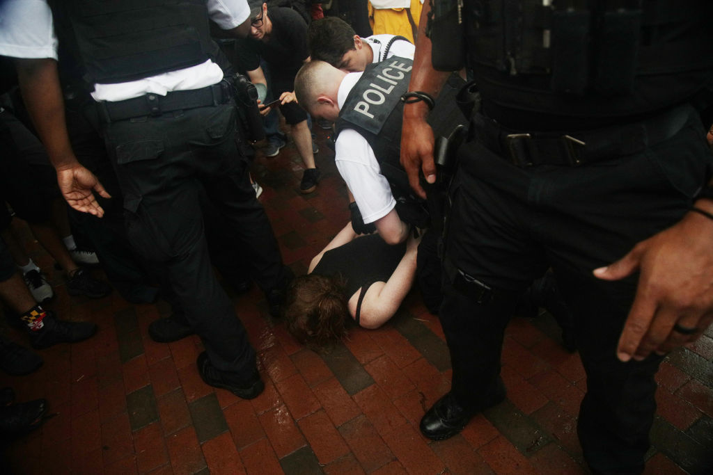 WASHINGTON, DC - JULY 04: A protester is restrained from a fight with Trump supporters by members of the U.S. Secret Service after an attempted flag burning in front of the White House on Independence Day July 4th, 2019 in Washington, DC. President Trump is holding a "Salute to America" celebration on the National Mall on Independence Day this year with musical performances, a military flyover, and fireworks. (Photo by Alex Wong/Getty Images)