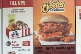 The KFC Cheetos Sandwich introduced Monday includes a fried chicken breast drizzled with neon orange sauce that a WTOP staffer described as looking radioactive, but it doesn't pack that powerful of a punch. (WTOP/Kristi King)