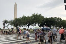 People walk around 15th Street and Constitution Avenue by the National Mall on Thursday, July 4, 2019. (WTOP/Michelle Basch)