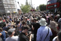 The road is blocked and the crossing obscured as thousands of fans gather to walk across the Abbey Road zebra crossing on the 50th anniversary of British pop musicians The Beatles doing it for their album cover of 'Abbey Road' in St Johns Wood in London, Thursday, Aug. 8, 2019. They aimed to cross 50 years to the minute since the 'Fab Four' were photographed for the album. (AP Photo/Kirsty Wigglesworth)