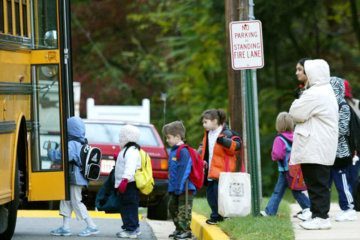 Children step onto school bus.