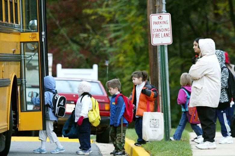 Children step onto school bus.