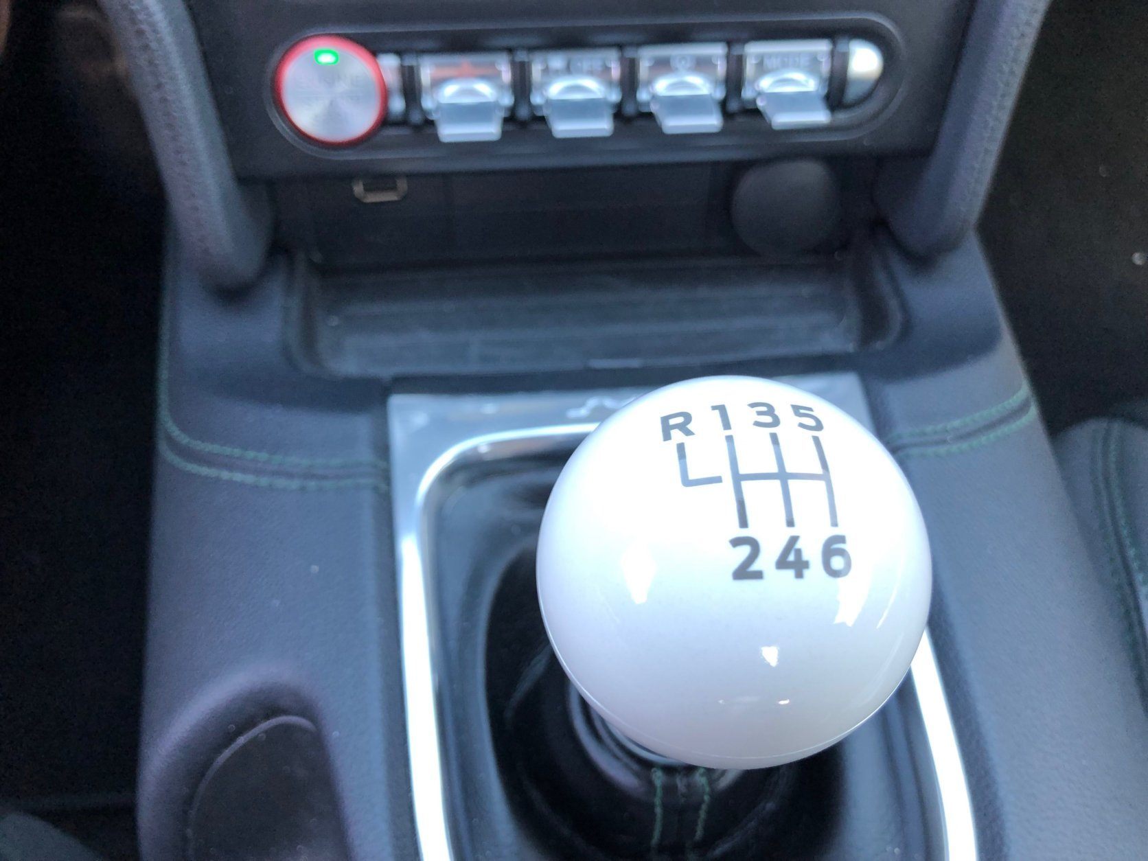 <p>The modern car’s white cue ball shifter is a thing of simplistic beauty. Great exhaust rumble while driving. Highland Green paint sparkles in the sun thanks to blue, yellow, and silver metal flakes.</p>
