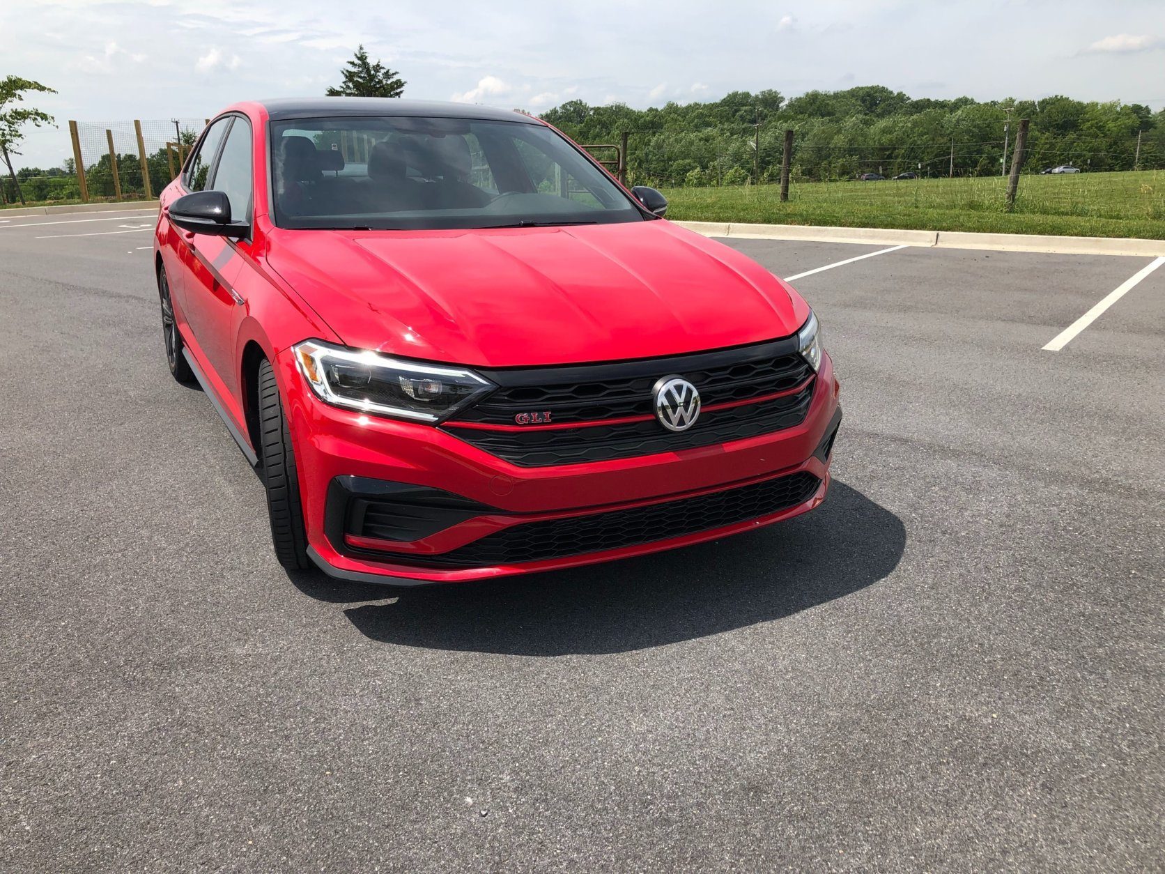 <p>On the outside the 2019 Jetta GLI has been transformed from plain sedan to a sporty one with just a few changes. A more aggressive front end with a blacked-out grill signals this is “no plain Jane” Jetta.</p>
<p>There are unique badges and red lines on the wheels and the front grill. Those touches might be a little boy racer for me, but it adds to a playful sedan that looks like it cost more than the sub $28,000 price tag.</p>

