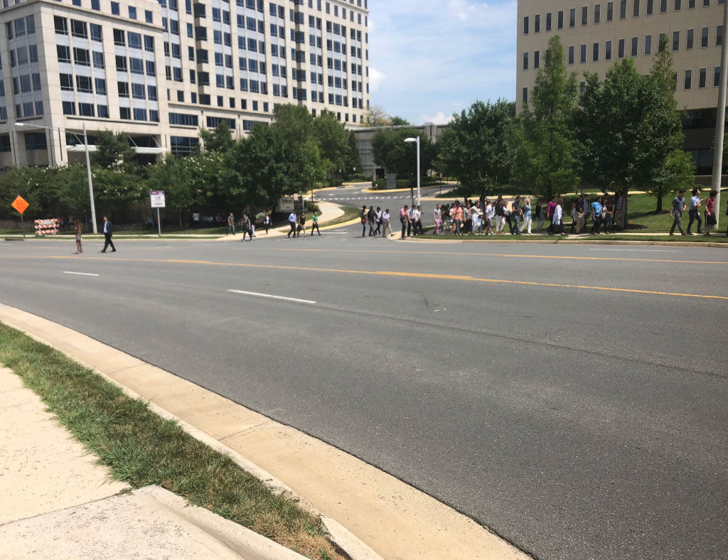 People are seen outside after the Gannett building was evacuated on Wednesday, Aug. 7, 2019. 
