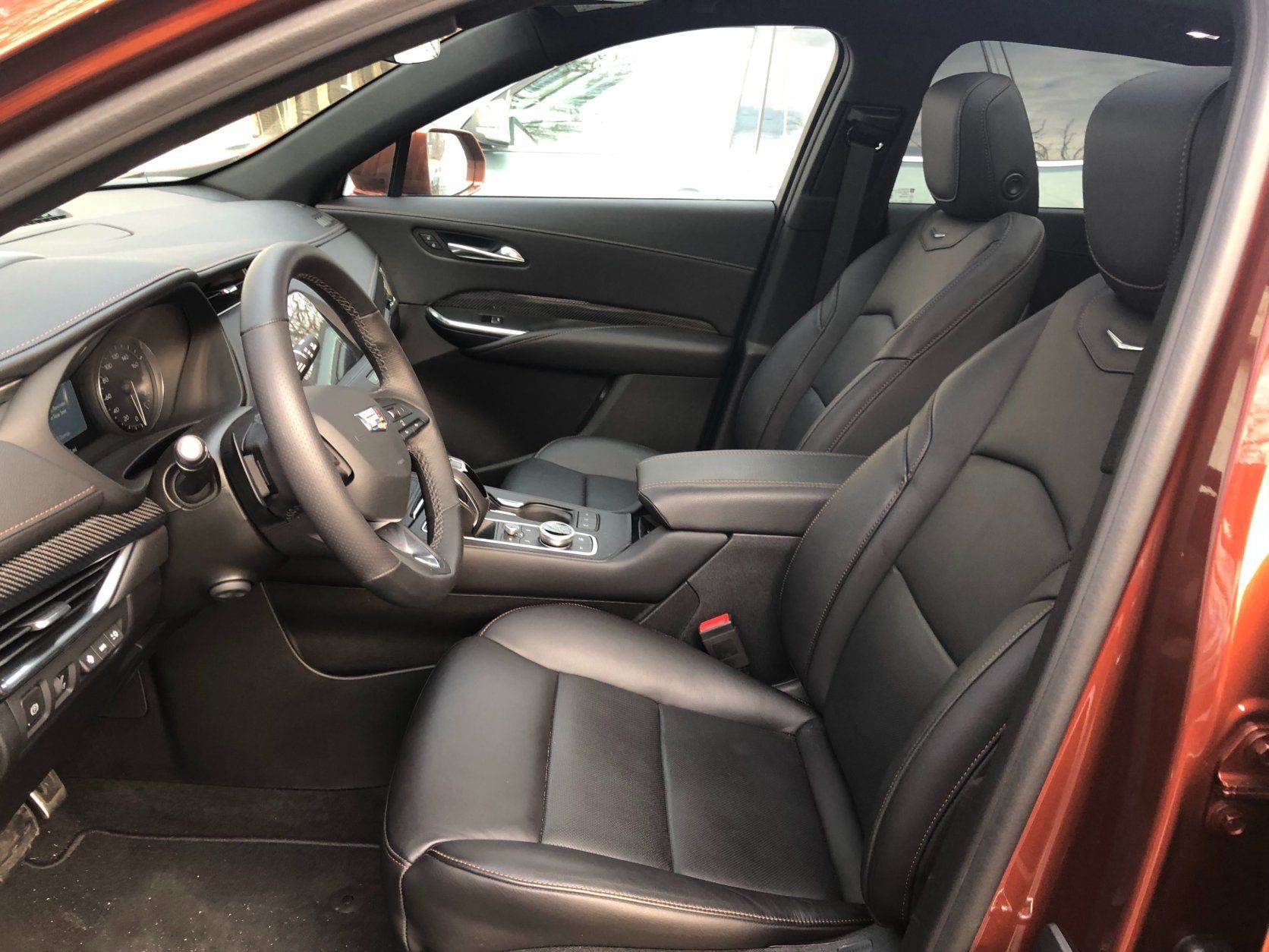 <p>While the new Cadillac is small on the outside, it’s surprisingly spacious on the inside. There is adequate space for those riding up front and two adults can fit in the back without much hassle.</p>
<p>Materials in the interior are a mixed bag of really high quality with some cheaper plastics. Nice dash and top half of door panels lead to lower hard plastics that are mostly out of sight.</p>
