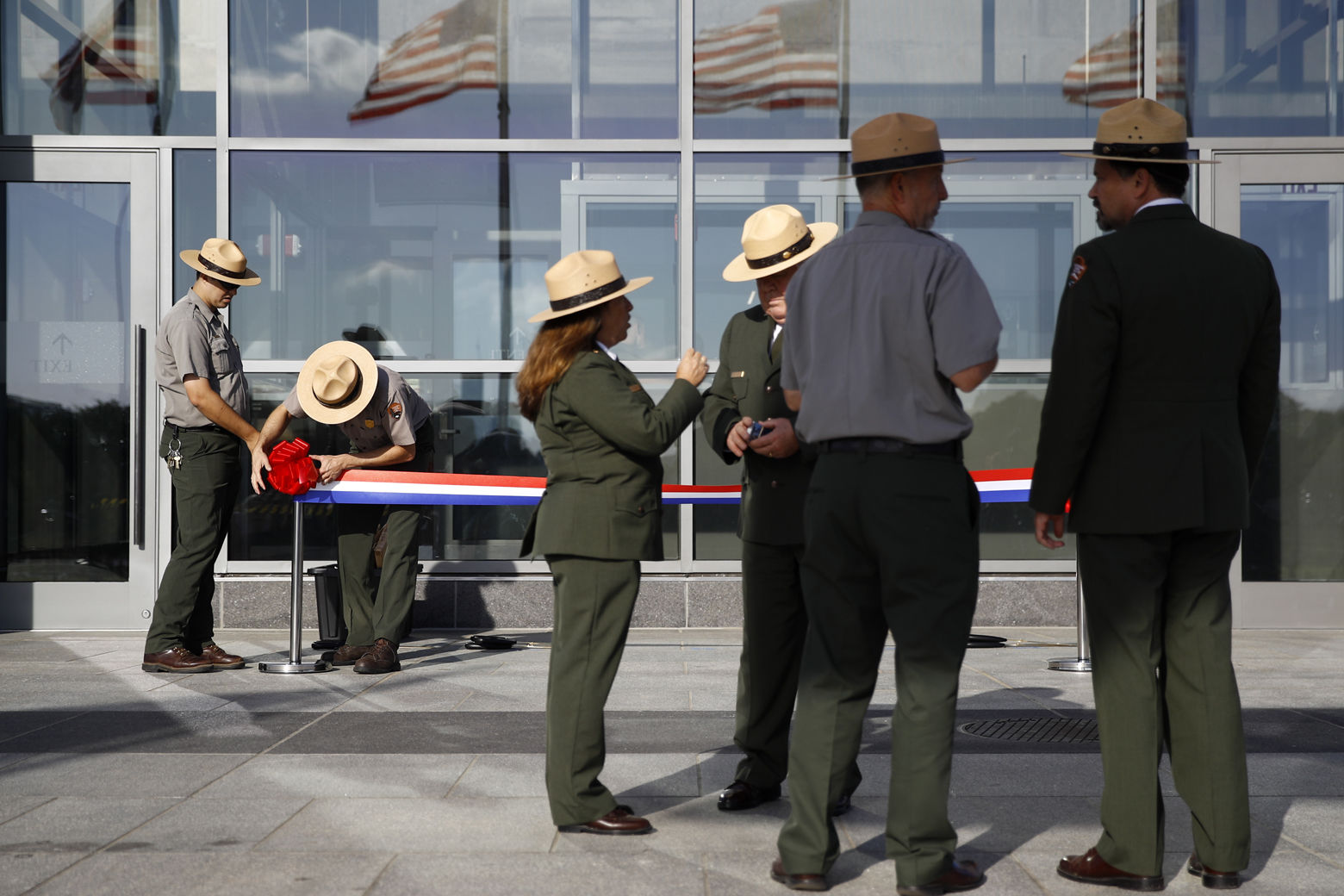 National Park Service rangers prepare a ribbon for a ribbon-cutting ceremony with first lady Melania Trump to re-open the Washington Monument, Thursday, Sept. 19, 2019, in Washington. The monument has been closed to the public for renovations since August 2016. (AP Photo/Patrick Semansky)