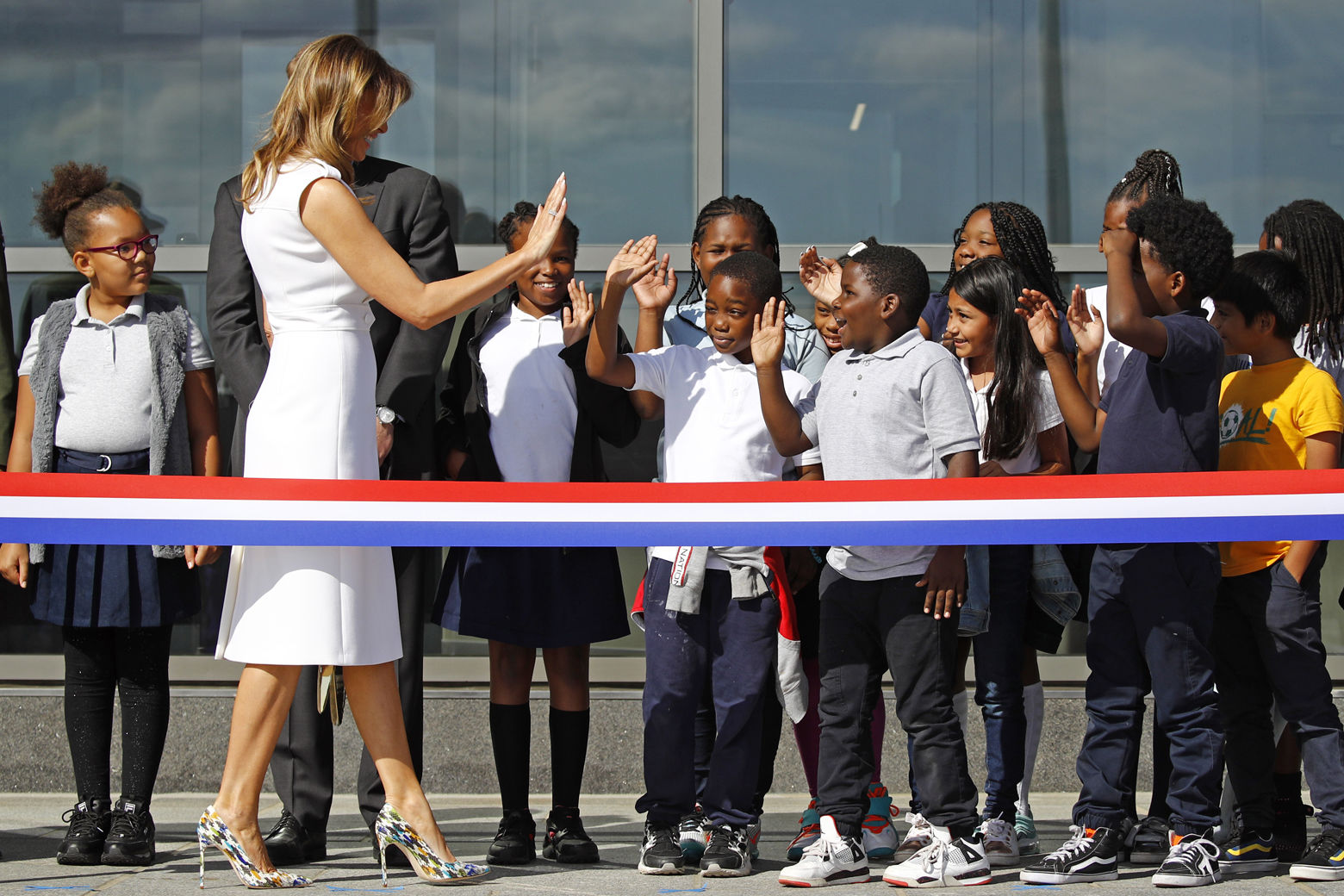 First lady Melania Trump high-fives students from Amidon-Bowen Elementary School in Washington as she arrives at a ribbon-cutting ceremony to re-open the Washington Monument, Thursday, Sept. 19, 2019, in Washington. The monument has been closed to the public for renovations since August 2016. (AP Photo/Patrick Semansky)