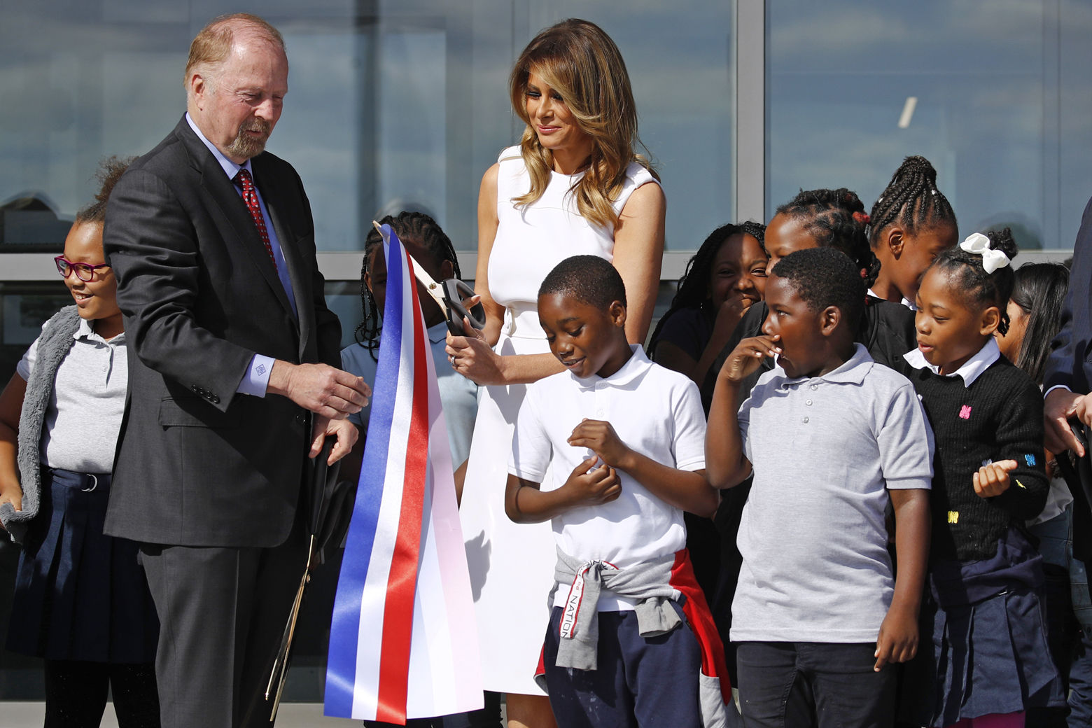 First lady Melania Trump, center, and Department of Interior assistant secretary Rob Wallace, left, participate in a ribbon-cutting ceremony with students from Amidon-Bowen Elementary School in Washington to re-open the Washington Monument, Thursday, Sept. 19, 2019, in Washington. The monument has been closed to the public for renovations since August 2016. (AP Photo/Patrick Semansky)