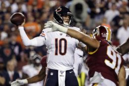 Chicago Bears quarterback Mitchell Trubisky (10) looks to pass under pressure from Washington Redskins outside linebacker Ryan Kerrigan (91) during the first half of an NFL football game Monday, Sept. 23, 2019, in Landover, Md. (AP Photo/Julio Cortez)