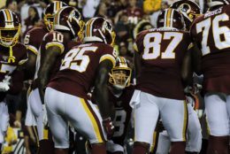 Washington Redskins quarterback Case Keenum (8) calls a play in the huddle during the first half of an NFL football game against the Chicago Bears, Monday, Sept. 23, 2019, in Landover, Md. (AP Photo/Mark Tenally)