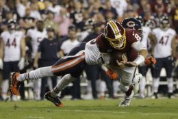 Washington Redskins quarterback Case Keenum (8) is sacked by Chicago Bears safety Eddie Jackson (39) during the first half of an NFL football game Monday, Sept. 23, 2019, in Landover, Md. (AP Photo/Julio Cortez)