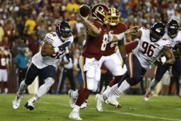 Washington Redskins quarterback Case Keenum (8) throws under pressure from Chicago Bears linebacker Khalil Mack (52) and tackle Akiem Hicks (96) during the first half of an NFL football game Monday, Sept. 23, 2019, in Landover, Md. (AP Photo/Patrick Semansky)