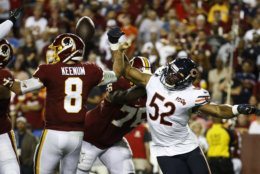Washington Redskins quarterback Case Keenum (8) loses the ball as he is hit by Chicago Bears outside linebacker Khalil Mack (52) during the first half of an NFL football game Monday, Sept. 23, 2019, in Landover, Md. (AP Photo/Patrick Semansky)