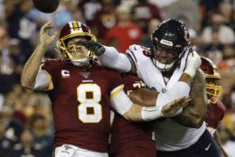Chicago Bears outside linebacker Khalil Mack (52) hits Washington Redskins quarterback Case Keenum (8) to cause a fumble during the first half of an NFL football game Monday, Sept. 23, 2019, in Landover, Md. (AP Photo/Julio Cortez)