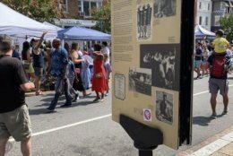 A sign tells visitors the history of the block they walk on in Adams Morgan. 