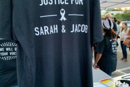 A shirt displayed at the vigil demands answers in the five-year-old case.