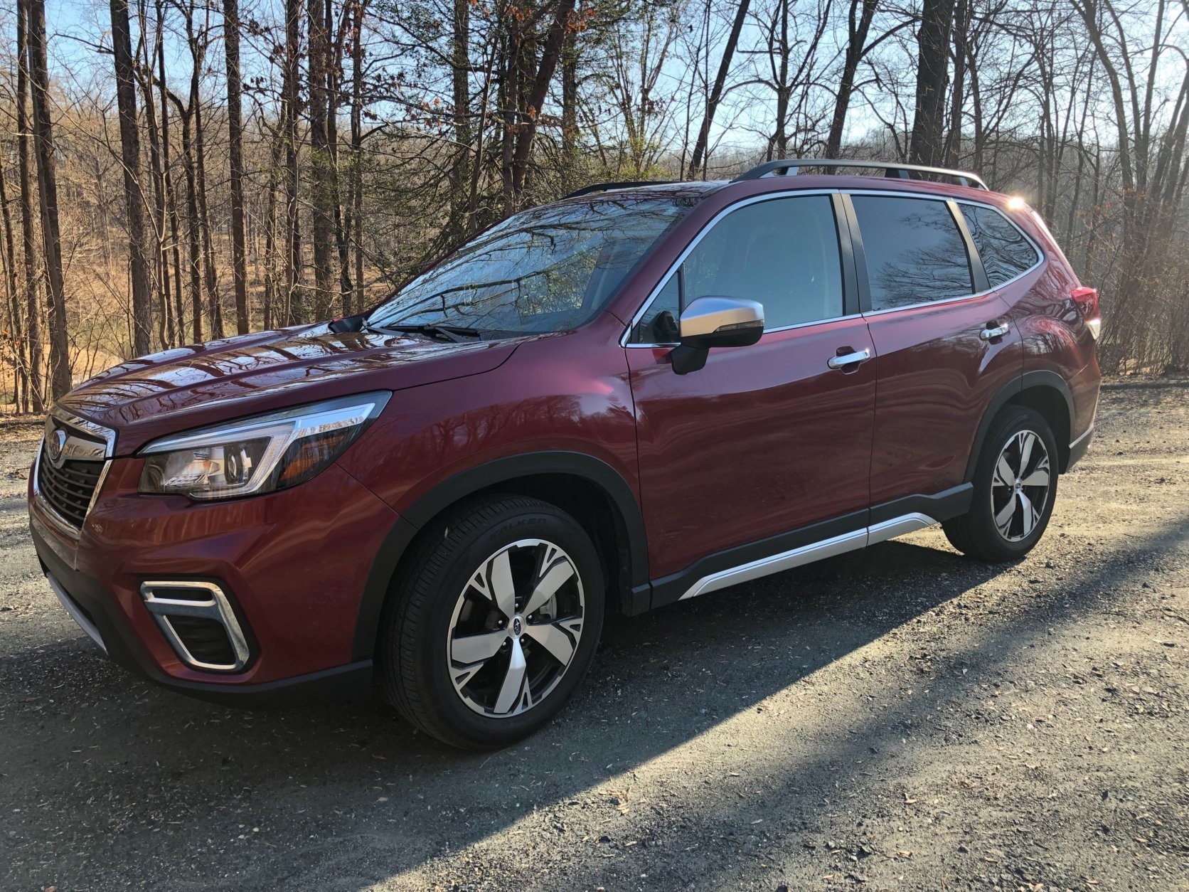 <p>This new Subaru Forester has more of an SUV look than the larger, taller wagon from before. It’s not a huge change but a more squared and chiseled — a more rugged appearance.</p>
<p>It’s still a bit more car-like than full on SUV and its welcome for some who want all capability and size without hulking size. The Forester sits up high but it doesn’t seem very tall and cumbersome like some other compact crossovers.</p>
<p>The SUV look carries forward with lower body cladding in black and silver adding a rough-and-ready, hit-the-trail style. It contrasts well with the Crimson Red pearl paint.</p>
<p>Added convenience with a roof rack expands storage options.</p>
