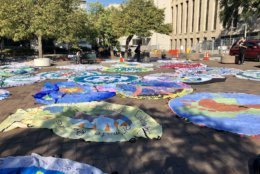 Climate protesters brought decorated parachutes to the area around the Newseum, in D.C., before the beginning of the march. (WTOP/Nick Iannelli)