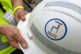 Project logo on construction worker's helmet