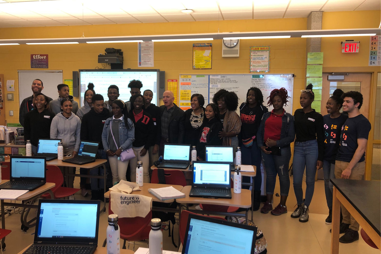 Computer science students at Dunbar High pose with Amazon CEO Jeff Bezos. (WTOP/Melissa Howell)
