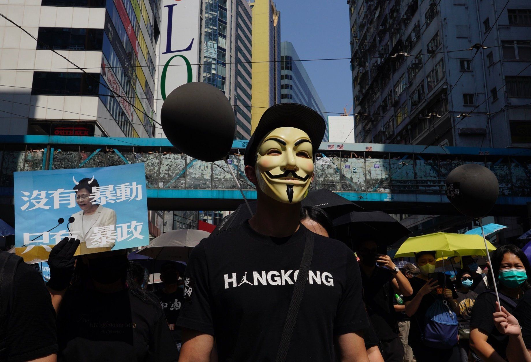 anti-government protesters in hong kong wear masks