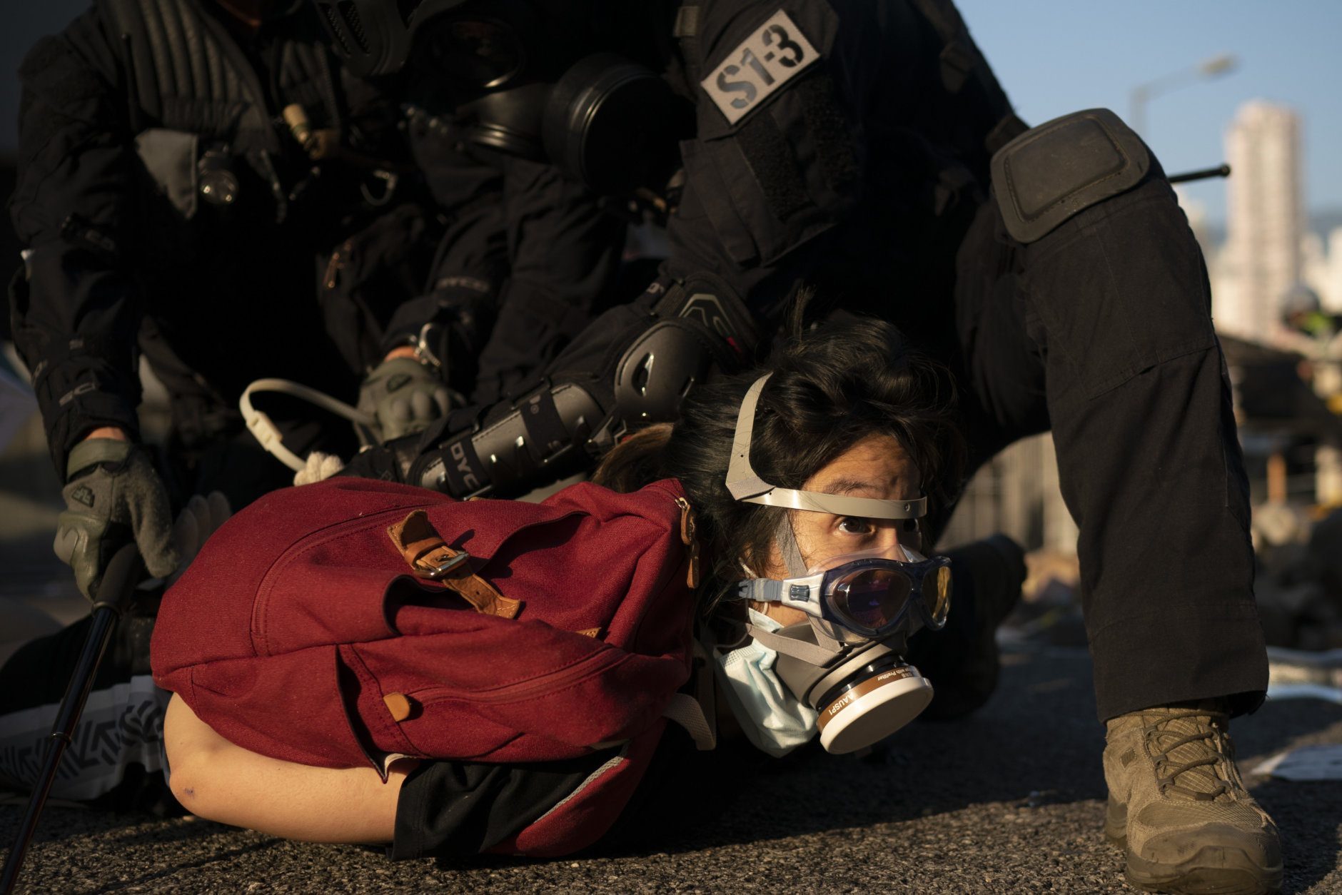 hong kong police hold down protester