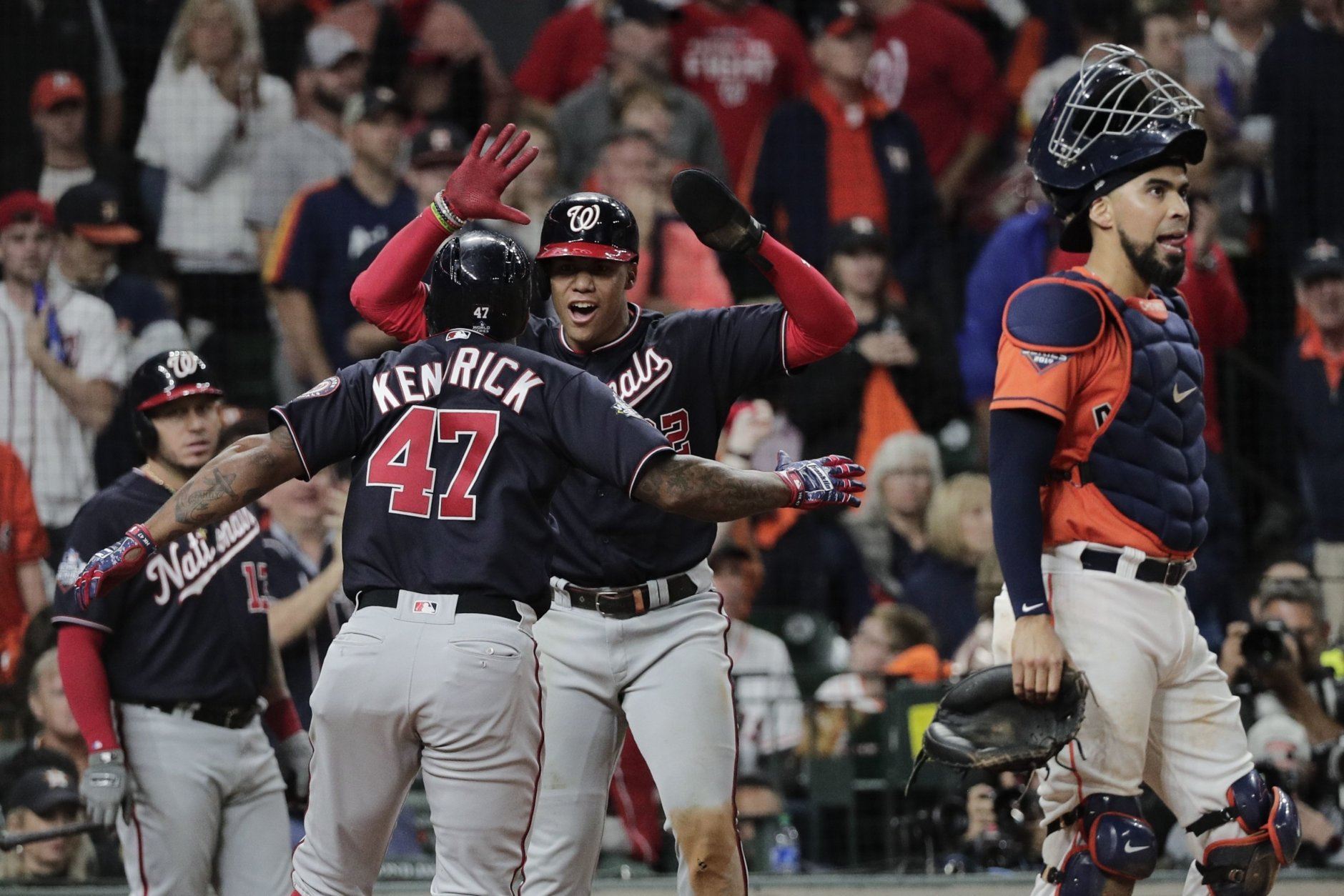Washington Nationals' Howie Kendrick is congratulated by Juan Soto after hitting a two-run home run during the seventh inning of Game 7 of the baseball World Series against the Houston Astros Wednesday, Oct. 30, 2019, in Houston. (AP Photo/David J. Phillip)