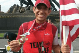 Jorge Garcia with flag and Iwo Jima memorial