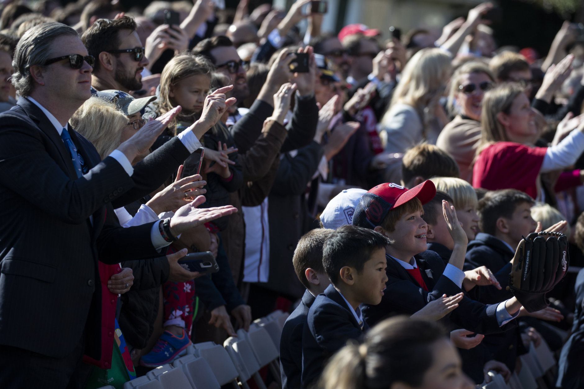 Fans do the "Baby Shark" during an event to honor the 2019 World Series Champion Washington Nationals baseball team, at the White House, Monday, Nov. 4, 2019, in Washington. (AP Photo/ Evan Vucci)