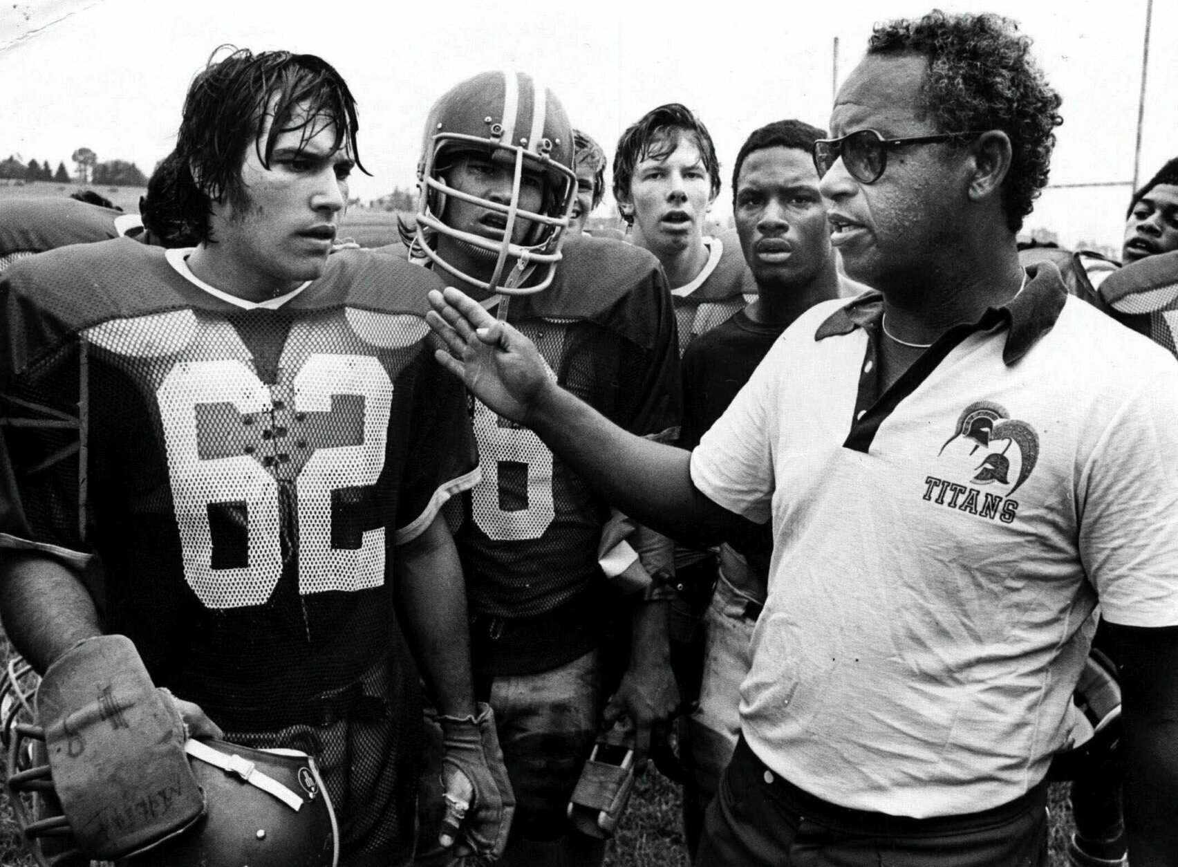 Alexandria, Va's., T.C. Williams High School football coach Herman Boone, right, during a break at summer camp, in 1971, with guard Johnny Colantuoni, (62) and John Vaughn, center. The famous 1971 team will be memorialized by Denzel Washington and Disney films in "Remember the Titans." (AP Photo)
