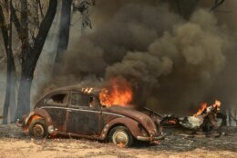 TOPSHOT - An old car burns from bushfires in Balmoral, 150 kilometres southwest of Sydney on December 19, 2019. - A state of emergency was declared in Australia's most populated region on December 19, as a record heat wave fanned unprecedented bushfires. (Photo by PETER PARKS / AFP) (Photo by PETER PARKS/AFP via Getty Images)