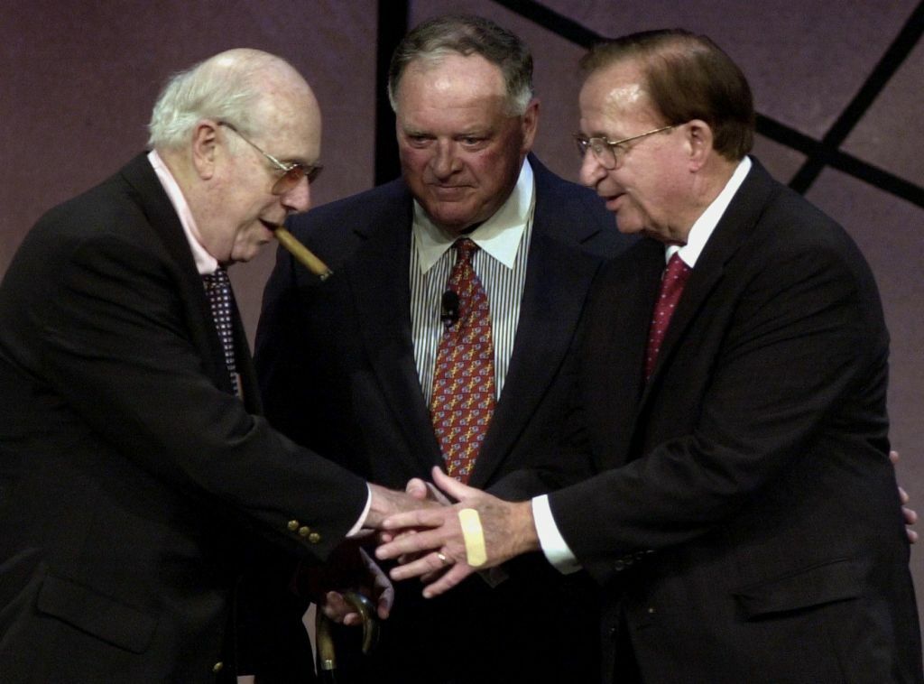 Morgan Wootten (R), who has been named Washington, DC, high school Basketball Coach of the Year ten times, is congratulated by former Boston Celtic's coach Red Auerbach (L) and Dave Gavit chairman of the board of the Basketball Hall of Fame (C) after Wootten was inducted into the 2000 Basketball Hall of Fame in Springfield, Massachusetts, Civic Center 13, October, 2000. Wootten is the high school coach with the most wins 1,213. (FILM)  AFP PHOTO  JOHN MOTTERN (Photo by JOHN MOTTERN / AFP) (Photo by JOHN MOTTERN/AFP via Getty Images)