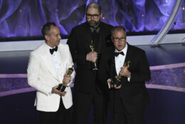 Jonas Rivera, from left, Josh Cooley and Mark Nielsen accept the award for best animated feature film for "Toy Story 4" at the Oscars on Sunday, Feb. 9, 2020, at the Dolby Theatre in Los Angeles. (AP Photo/Chris Pizzello)