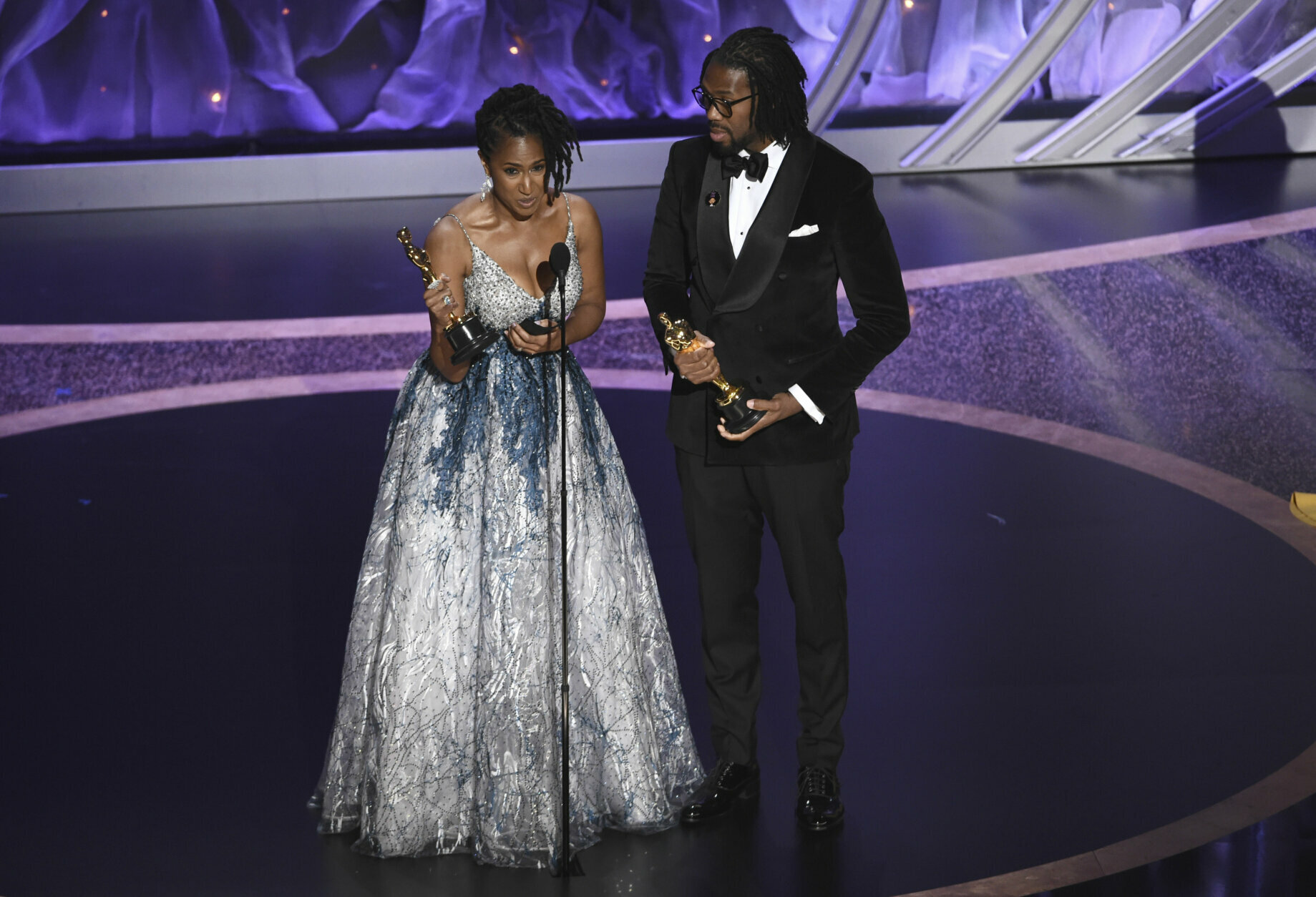 Karen Rupert Toliver, left, and Matthew A. Cherry accept the award for best animated short film for "Hair Love" at the Oscars on Sunday, Feb. 9, 2020, at the Dolby Theatre in Los Angeles. (AP Photo/Chris Pizzello)