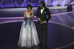 Karen Rupert Toliver, left, and Matthew A. Cherry accept the award for best animated short film for "Hair Love" at the Oscars on Sunday, Feb. 9, 2020, at the Dolby Theatre in Los Angeles. (AP Photo/Chris Pizzello)