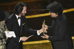 Diane Keaton, from left, and Keanu Reeves present the award for best original screenplay to Bong Joon Ho for "Parasite" at the Oscars on Sunday, Feb. 9, 2020, at the Dolby Theatre in Los Angeles. (AP Photo/Chris Pizzello)