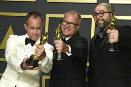 Jonas Rivera, from left, Mark Nielsen, and Josh Cooley, winners of the award for best animated feature film for "Toy Story 4", pose in the press room at the Oscars on Sunday, Feb. 9, 2020, at the Dolby Theatre in Los Angeles. (Photo by Jordan Strauss/Invision/AP)