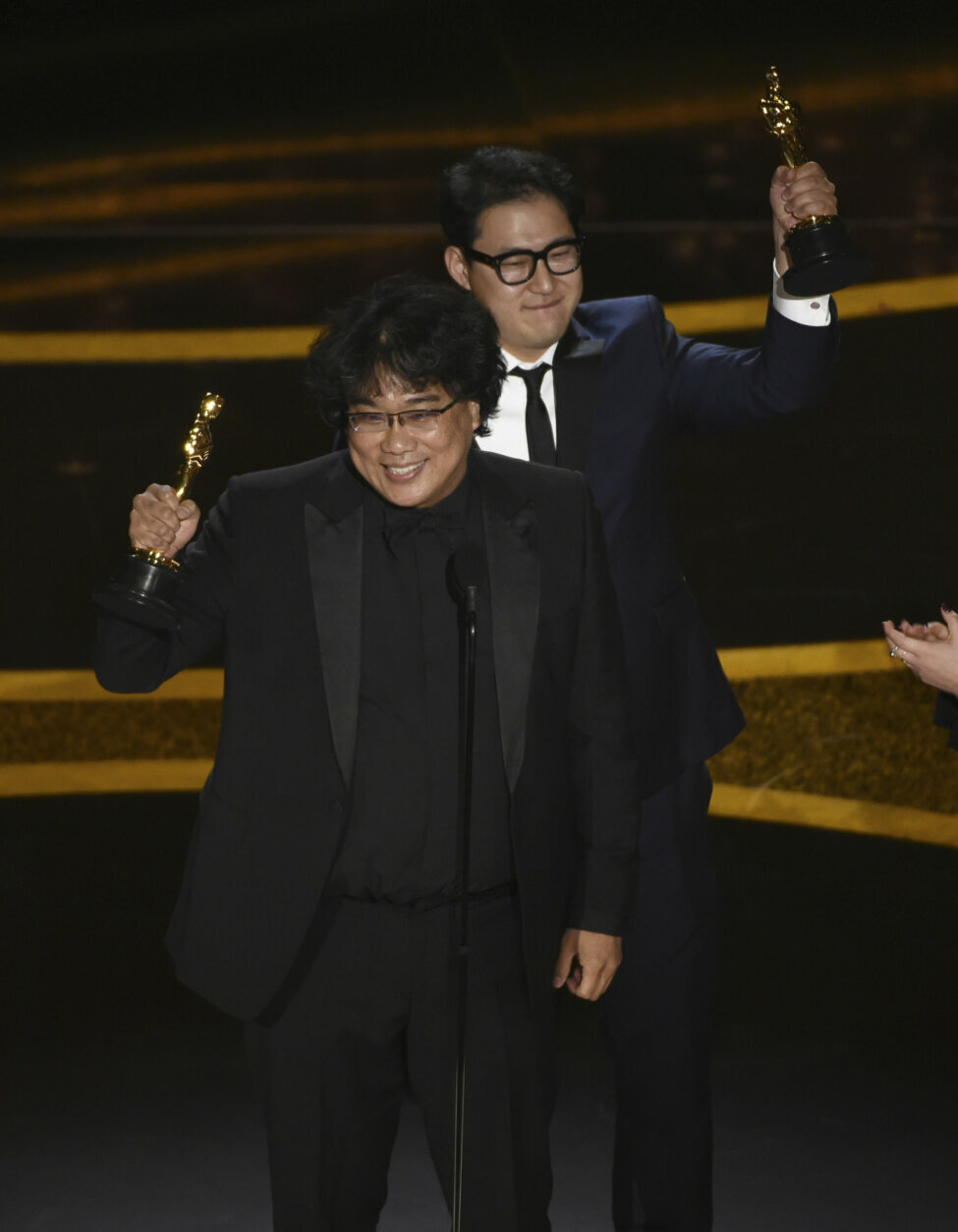 Bong Joon Ho, left, and Han Jin Won accept the award for best original screenplay for "Parasite" at the Oscars on Sunday, Feb. 9, 2020, at the Dolby Theatre in Los Angeles. (AP Photo/Chris Pizzello)