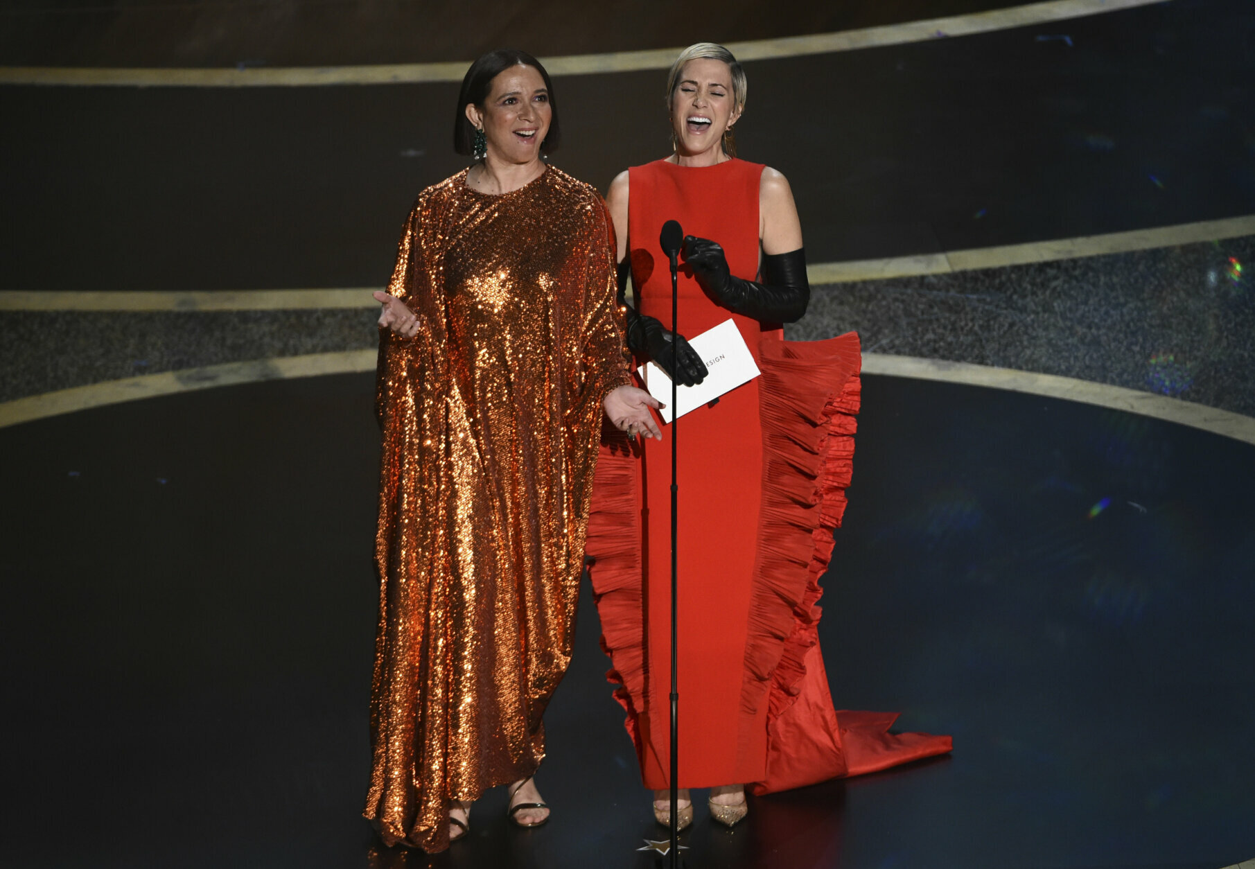 Maya Rudolph, left, and Kristen Wiig present the award for best costume design at the Oscars on Sunday, Feb. 9, 2020, at the Dolby Theatre in Los Angeles. (AP Photo/Chris Pizzello)