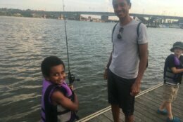 A father and child at a Friday Night Fishing event near Nats Park in the summer of 2019.