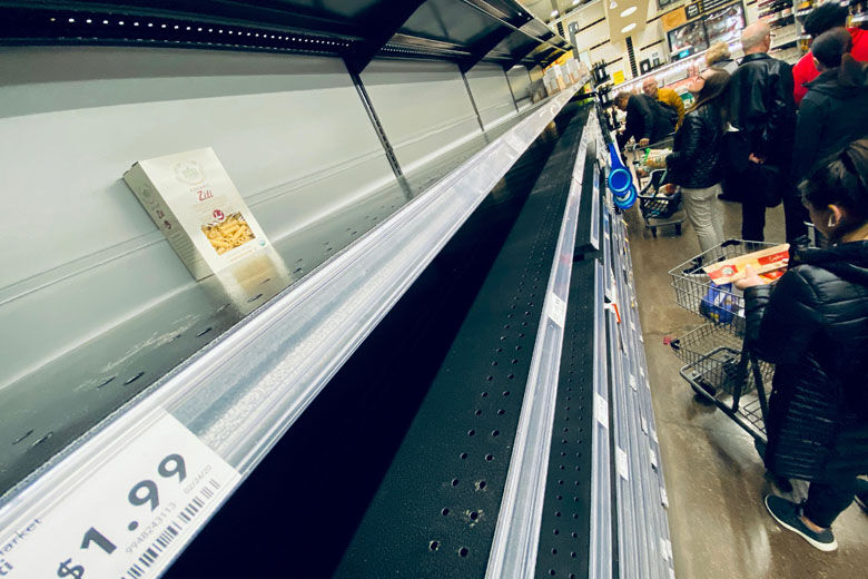 Shoppers looks at empty shelves of pasta in a downtown supermarket on March 11, 2020 in Washington, DC. - People start stocking on non perishable food as the fear of the the novel coronavirus, COVID-19, contagion is rising in the US Capital. (Photo by Eric BARADAT / AFP) (Photo by ERIC BARADAT/AFP via Getty Images)