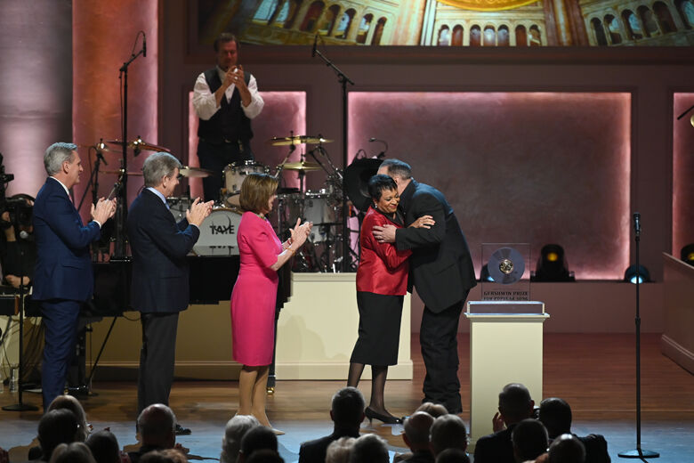 WASHINGTON, DC - MARCH 04: Musician Garth Brooks embraces the Librarian of Congress, Dr. Carla Hayden, as Speaker of the House Nancy Pelosi, Majority Leader Steny Hoyer, and Congressman Kevin McCarthy look on at The Library of Congress Gershwin Prize tribute concert at DAR Constitution Hall on March 04, 2020 in Washington, DC. (Photo by Shannon Finney/Getty Images)