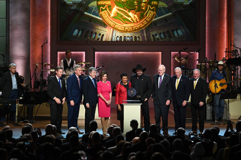WASHINGTON, DC - MARCH 04: Dr. Carla Hayden, the Librarian of Congress (center) presents the Gershwin Prize to musician Garth Brooks surrounded by members of the U.S. House of Representatives and the United States Senate, including Speaker of the House Nancy Pelosi, at The Library of Congress Gershwin Prize tribute concert at DAR Constitution Hall on March 04, 2020 in Washington, DC. (Photo by Shannon Finney/Getty Images)